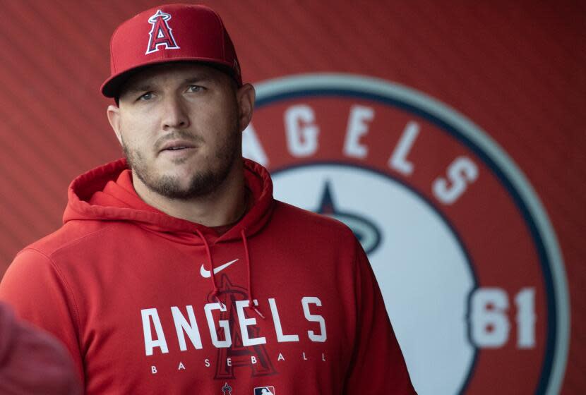 Anaheim, CA - July 18: Angels star Mike Trout walks in the dugout before a game.