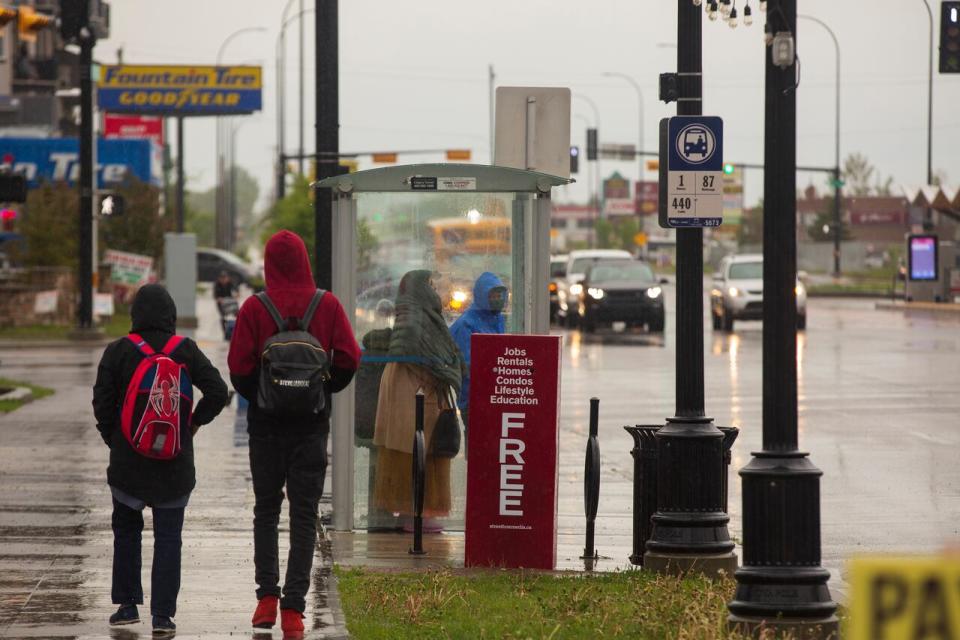 Calgarians brave the rain in Forest Lawn in the city's southeast on June 13, 2022. 