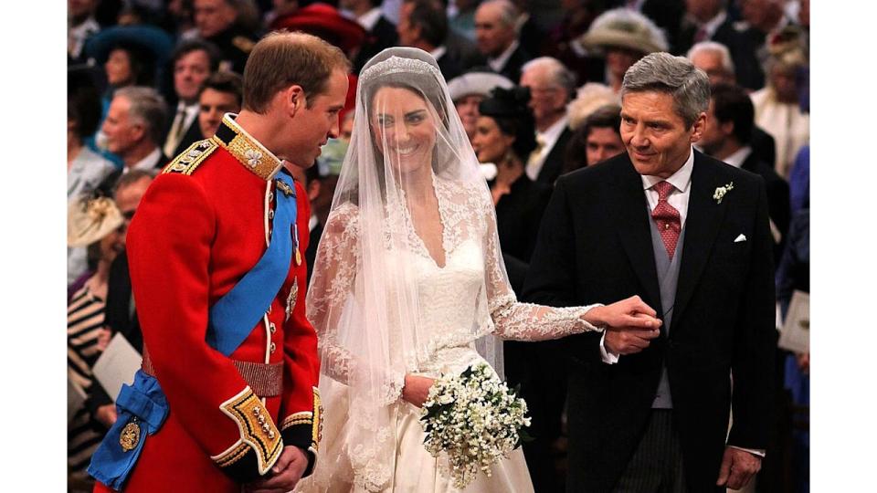 Prince William speaks to his bride Princess Kate and father-in-law Michael Middleton at Westminster Abbey