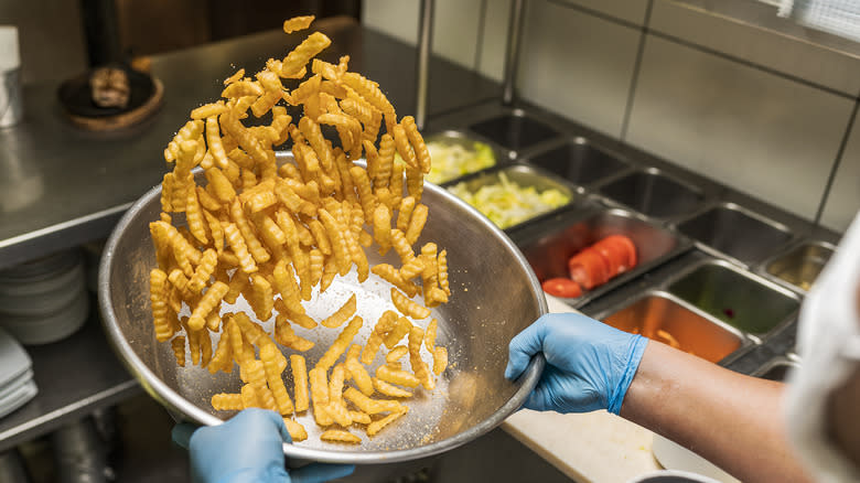 seasoning fries in a bowl