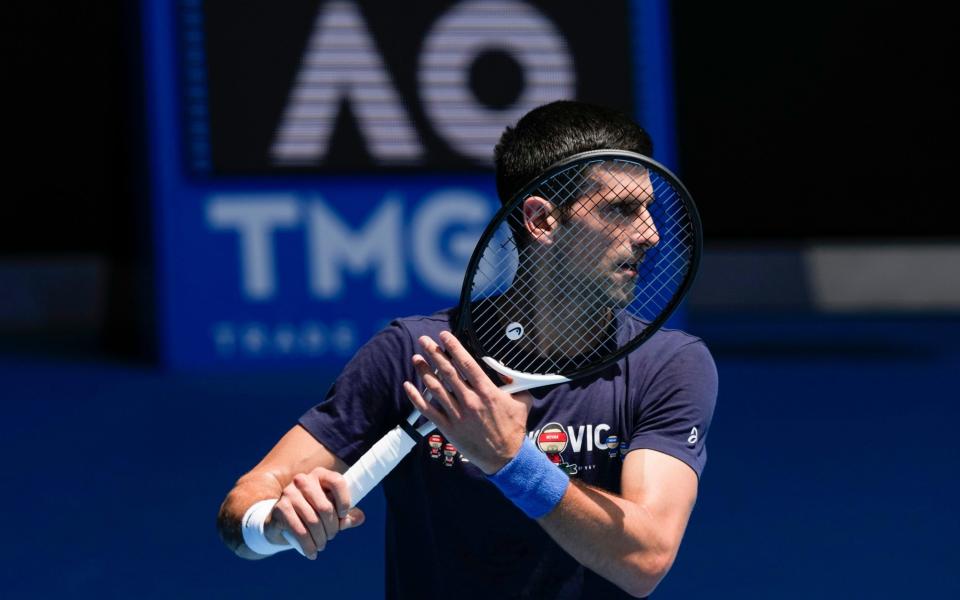 FILE - Defending men's champion Serbia's Novak Djokovic practices on Rod Laver Arena ahead of the Australian Open tennis championship in Melbourne, Australia, Jan. 12, 2022. Djokovicâ€™s effort to play in the Australian Open despite being unvaccinated for COVID-19 moved to a higher court as the No. 1-ranked tennis player appealed the second cancellation of his visa. A judge scheduled another hearing for Sunday, Jan. 16. (AP Photo/Mark Baker, File) - AP/Mark Baker 