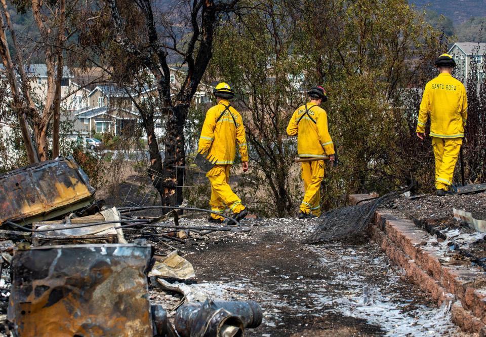 Santa Rosa firefighters examine the left over destruction in the Skyhawk neighborhood in Santa Rosa, Calif., on  Sept. 29, 2020.