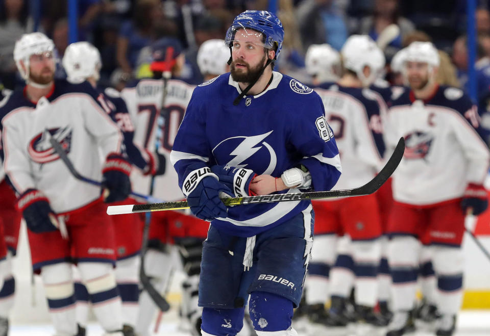 TAMPA, FL - APRIL 10: Nikita Kucherov #86 of the Tampa Bay Lightning reacts as members of the Columbus Blue Jackets celebrate at the end of Game One of the Eastern Conference First Round during the 2019 NHL Stanley Cup Playoffs at Amalie Arena on April 10, 2019 in Tampa, Florida. (Photo by Mike Carlson/Getty Images)