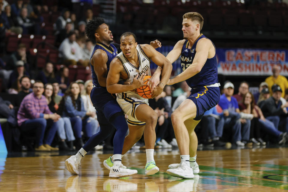 Montana State guard Darius Brown II (10) battles with two Northern Arizona defenders for the ball in the first half of an NCAA college basketball game for the championship of the Big Sky men's tournament in Boise, Idaho, Wednesday, March 8, 2023, i(AP Photo/Steve Conner)