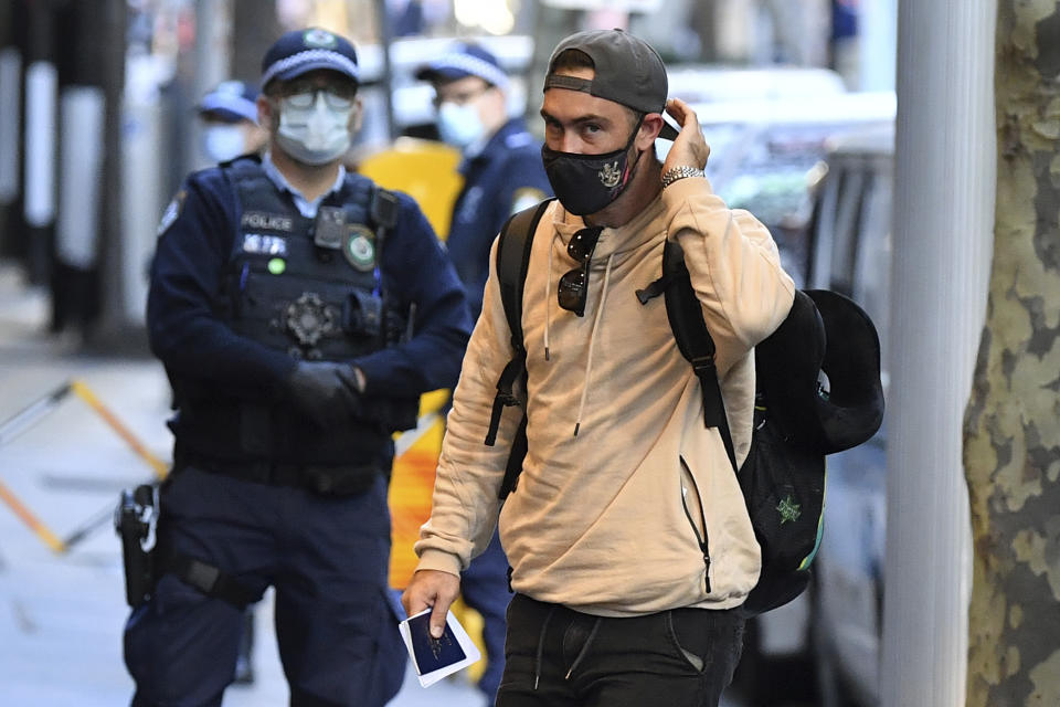 Australian cricketer Glenn Maxwell arrives for hotel quarantine at the Marriott Hotel in Sydney, Australia, Monday, May 17, 2021. Most of the Australians involved in the suspended Indian Premier League have arrived in Sydney on a charter flight and will go immediately into quarantine. (Joel Carrett/AAP Image via AP)