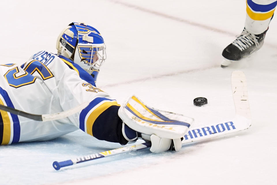 St. Louis Blues goaltender Ville Husso (35) dives to block the puck during the second period of an NHL hockey game against the Anaheim Ducks, Sunday, Jan. 31, 2021, in Anaheim, Calif. (AP Photo/Ashley Landis)
