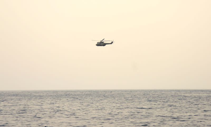 A helicopter searches for survivors after a boat capsized off the Lebanese coast of Tripoli overnight, near port of Tripoli