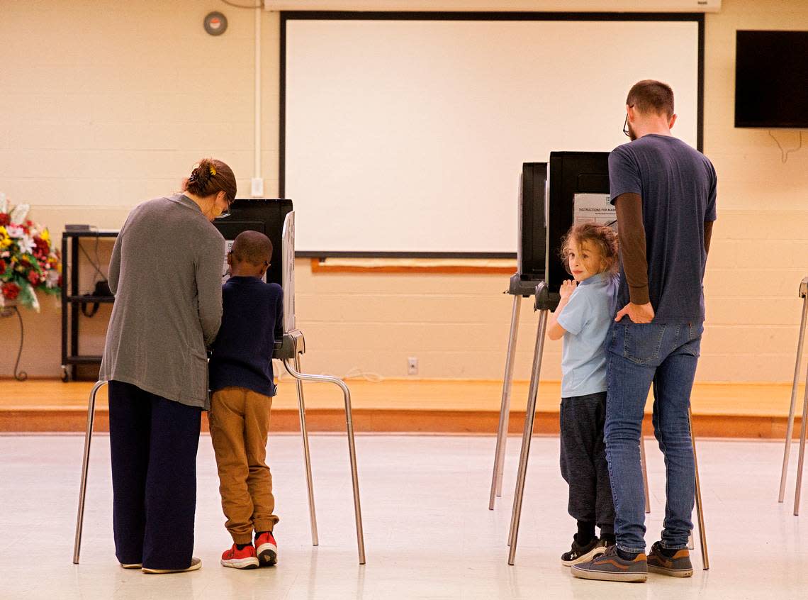 Laura Klein and Andrew Witkins vote with their children, Prince, 6, and Otis, 8, at White Rock Baptist Church on Tuesday, March 5, 2024, in Durham, N.C.