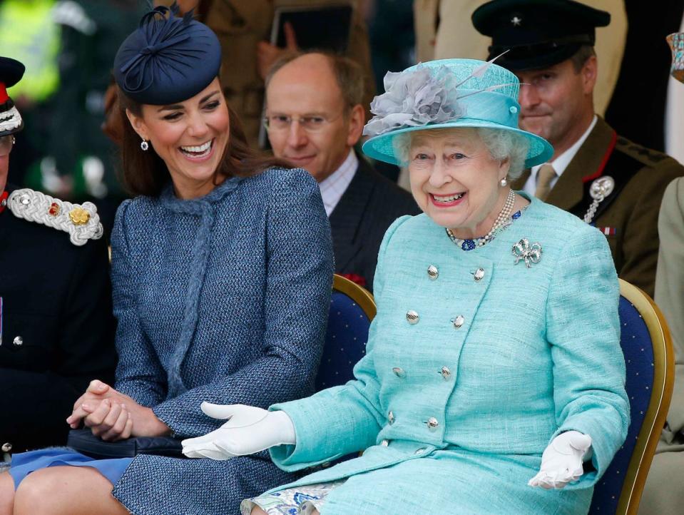 Catherine, Duchess of Cambridge laughs as Queen Elizabeth gestures during a visit to Vernon Park in Nottingham, 2012 (Getty)