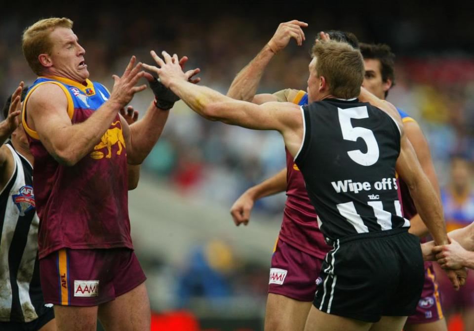 Nathan Buckley and Michael Voss clash on the field