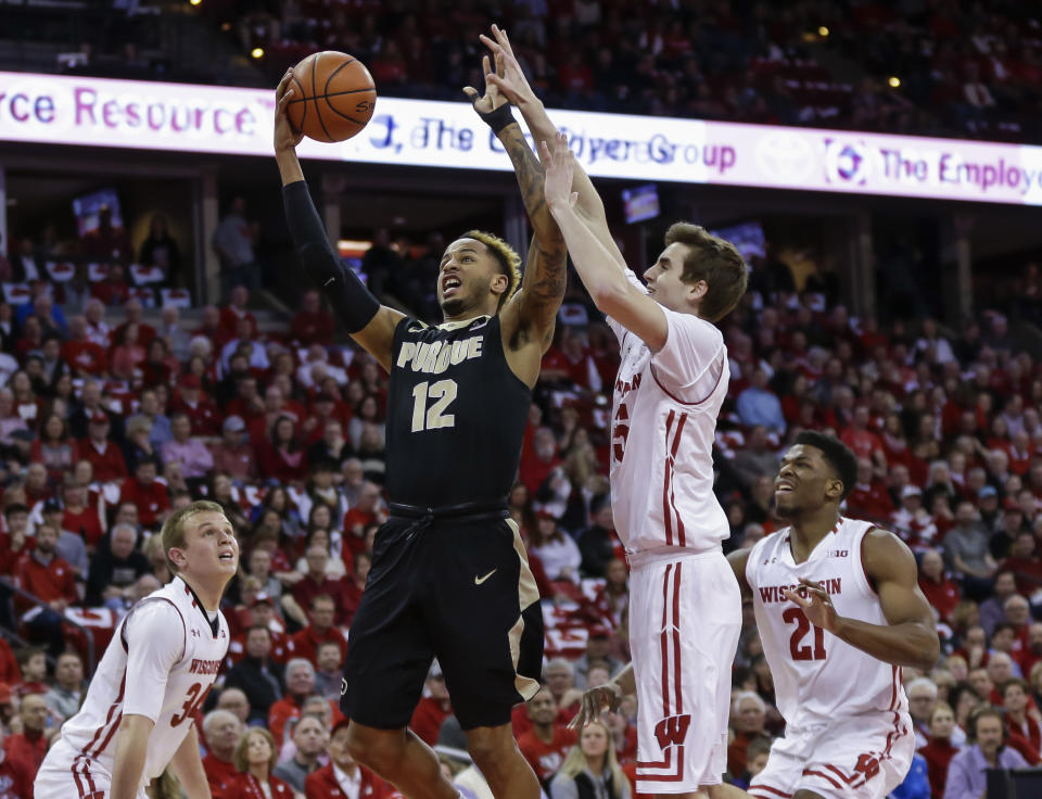 Purdue’s Vincent Edwards (12) shoots against Wisconsin’s Nate Reuvers (35) during the first half of an NCAA college basketball game Thursday, Feb. 15, 2018, in Madison, Wis. (AP Photo/Andy Manis)