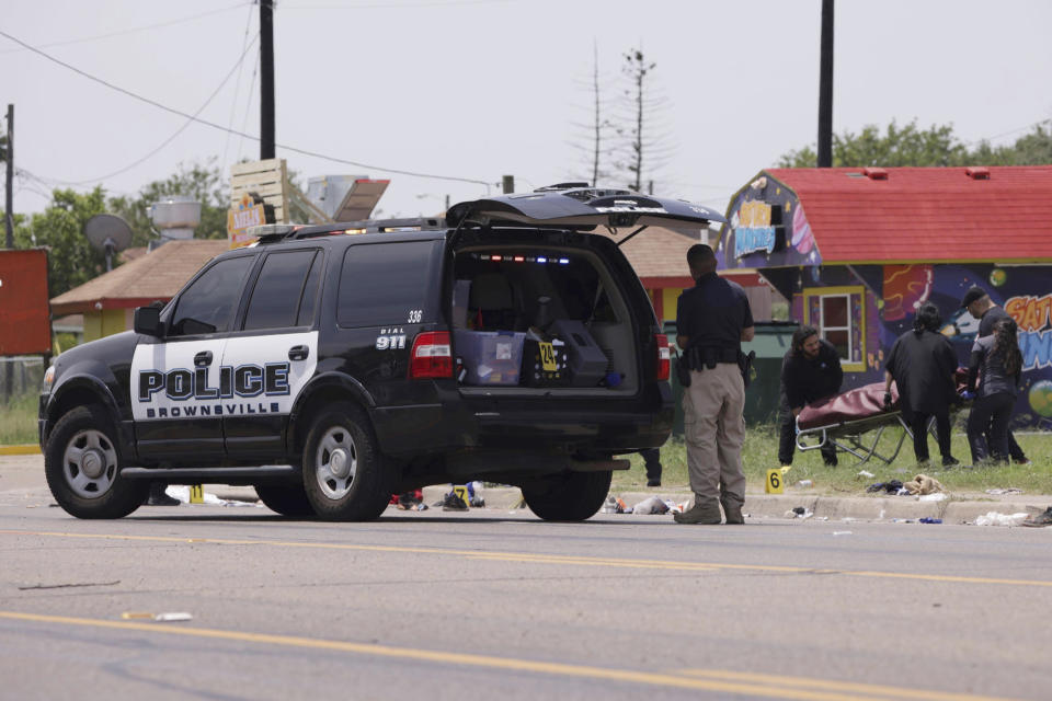 Emergency personnel respond to a fatal collision in Brownsville, Texas, on Sunday, May 7, 2023. Several migrants were killed after they were struck by a vehicle while waiting at a bus stop near Ozanam Center, a migrant and homeless shelter. (AP Photo/Michael Gonzalez)