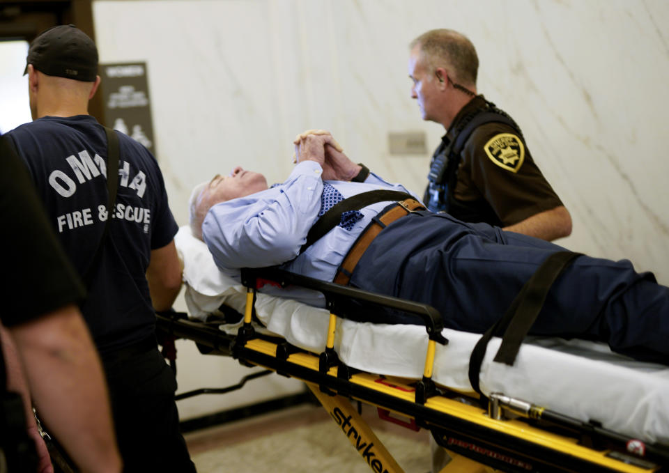 Douglas County Judge Gary Randall is taken from the courtroom by gurney after feeling unwell during the sentencing of former doctor Anthony Garcia, in Omaha, Neb., Friday, Sept. 14, 2018. Randall was on the three-judge panel that sentenced Garcia to death for the revenge killings of four people connected to a Nebraska medical school. Garcia, of Indiana, was convicted in two attacks that occurred five years apart. The first victims were the son and housekeeper of a faculty member at Creighton University School of Medicine in Omaha. Garcia also was found guilty in the 2013 deaths of another Creighton pathology doctor and his wife. (AP Photo/Nati Harnik)