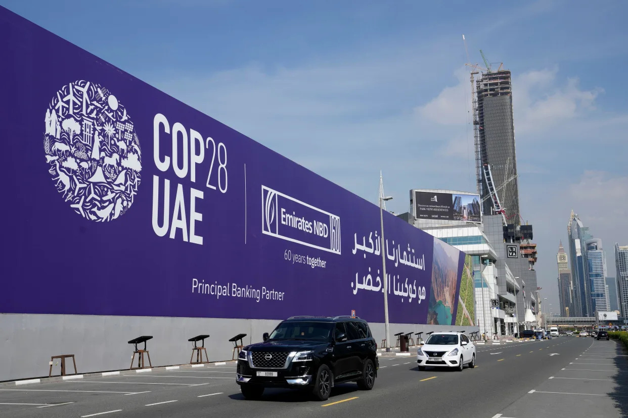 Cars pass by a billboard advertising COP28 at Sheikh Zayed highway in Dubai, United Arab Emirates, Monday, Nov. 27, 2023. Representatives will gather at Expo City in Dubai, UAE, Nov. 30 to Dec. 12 for the 28th U.N. Climate Change Conference, known as COP28. (AP Photo/Kamran Jebreili)