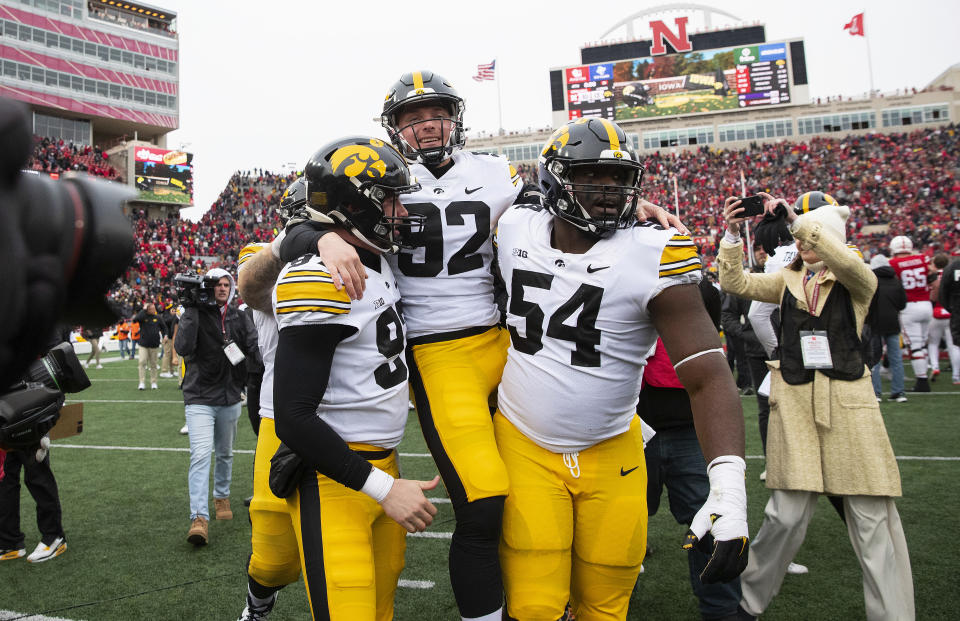 Iowa's Liam Reardon, left, and Anterio Thompson, right, carry kicker Marshall Meeder after he kicked a last-second field goal to defeat Nebraska 13-10 during an NCAA college football game, Friday, Nov. 24, 2023, in Lincoln, Neb. (AP Photo/Rebecca S. Gratz)
