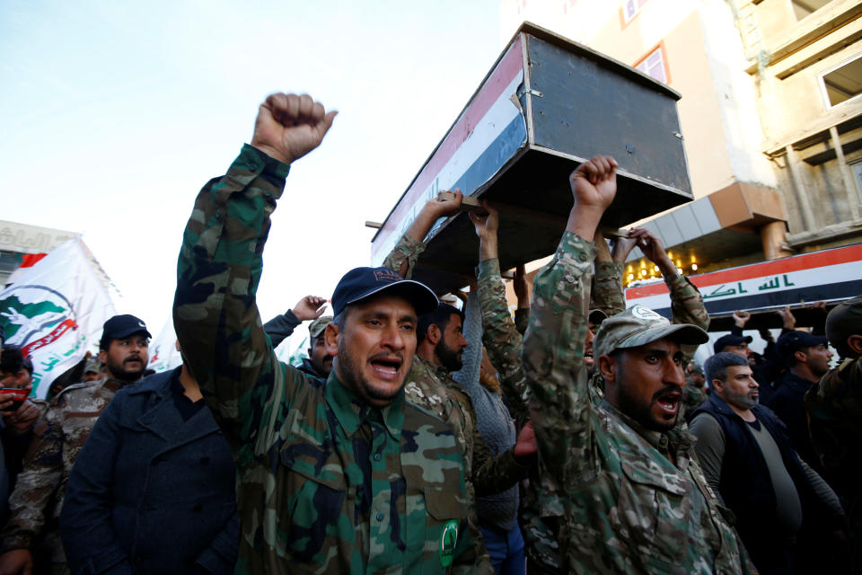 Hashd al-Shaabi (paramilitary forces) fighters carry coffins of members of Kataib Hezbollah militia group, who were killed by U.S. air strikes in Qaim district, during a funeral in the holy city of Najaf, Iraq December 31, 2019. REUTERS/Alaa al-Marjani