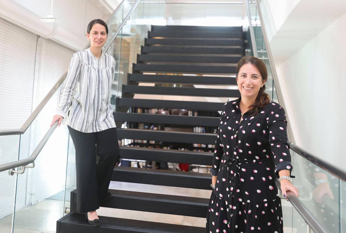 Curators Anelys Alvarez, left, and Patricia M. Hanna pose inside Espacio 23 where “You Know Who You Are” is currently on display. The exhibition highlights works centered around Cuban and Cuban diaspora art through history and through artists personal experiences.