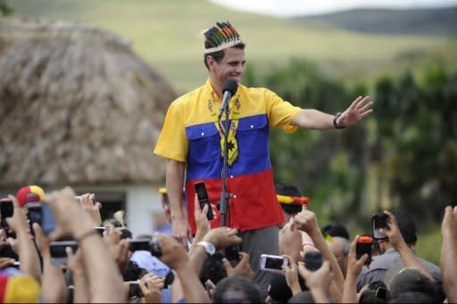 Venezuelan opposition candidate Henrique Capriles waves as he speaks during the opening rally of his campaign in San Francisco de Yuruani, Bolivar state, Venezuela on July 1, 2012