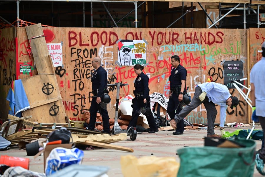 Police patrol as workers clean up the University of California, Los Angeles (UCLA) campus after police evicted pro-Palestinian students, in Los Angeles, California, early on May 2, 2024. Hundreds of police tore down protest barricades and began arresting students early Thursday at the University of California, Los Angeles – the latest flashpoint in an eruption of protest on US campuses over Israel’s war against Hamas in Gaza. (Photo by Frederic J. Brown / AFP) (Photo by FREDERIC J. BROWN/AFP via Getty Images)