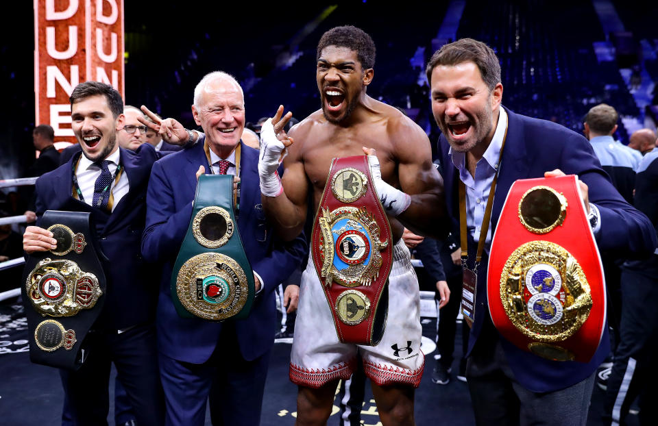 DIRIYAH, SAUDI ARABIA - DECEMBER 07: Anthony Joshua poses for a photo with the IBF, WBA, WBO & IBO World Heavyweight Title belts with Eddie Hearn and Barry Hearn after the IBF, WBA, WBO & IBO World Heavyweight Title Fight between Andy Ruiz Jr and Anthony Joshua during the Matchroom Boxing 'Clash on the Dunes' show at the Diriyah Season on December 07, 2019 in Diriyah, Saudi Arabia (Photo by Richard Heathcote/Getty Images)