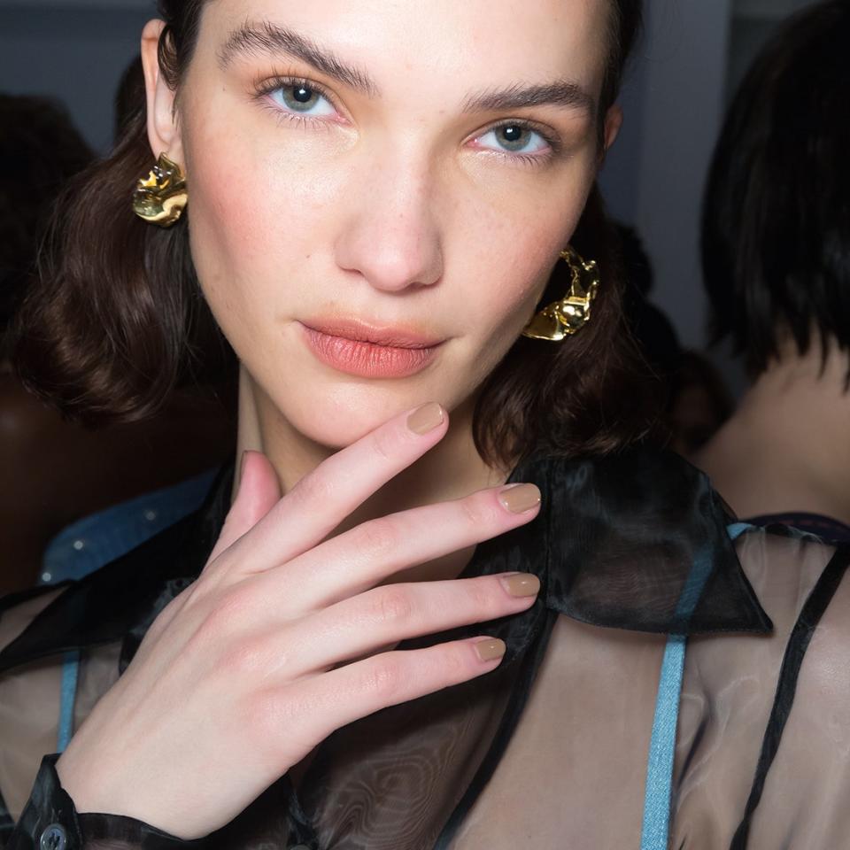 At the Staud Fall 2019 runway show, nail artist Naomi Gonzales-Longstaff painted models' nails in the most perfect neutral shade of light brown, <a href="https://www.amazon.com/d/Nail-Polish/ZOYA-Nail-Polish-Spencer/B01M7VR2RV" rel="nofollow noopener" target="_blank" data-ylk="slk:Zoya's Spencer;elm:context_link;itc:0;sec:content-canvas" class="link ">Zoya's Spencer</a>. Even with a little stripe of <a href="https://www.amazon.com/ZOYA-Polish-Kerry-Fluid-Ounce/dp/B00CMMYHAS" rel="nofollow noopener" target="_blank" data-ylk="slk:the shade Kerry;elm:context_link;itc:0;sec:content-canvas" class="link ">the shade Kerry</a>, a yellow-gold foil, it reads simple and sophisticated, not overly glitzy.