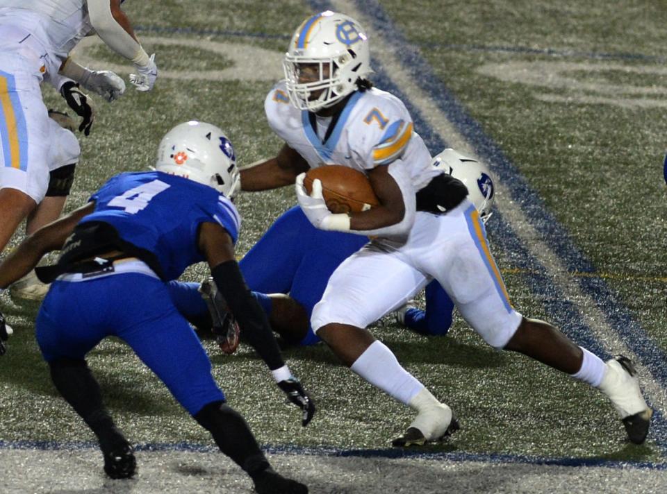 Maurki James (7) of Cape Henlopen tries to elude Dover's Amir Byrom during the Vikings' 25-20 win in the Class 3A playoffs on Friday night.