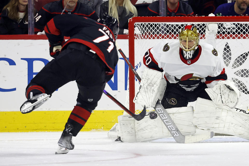 Ottawa Senators goaltender Joonas Korpisalo (70) blocks the penalty shot by Carolina Hurricanes' Jesper Fast (71) during the first period of an NHL hockey game in Raleigh, N.C., Wednesday, Oct. 11, 2023. (AP Photo/Karl B DeBlaker)