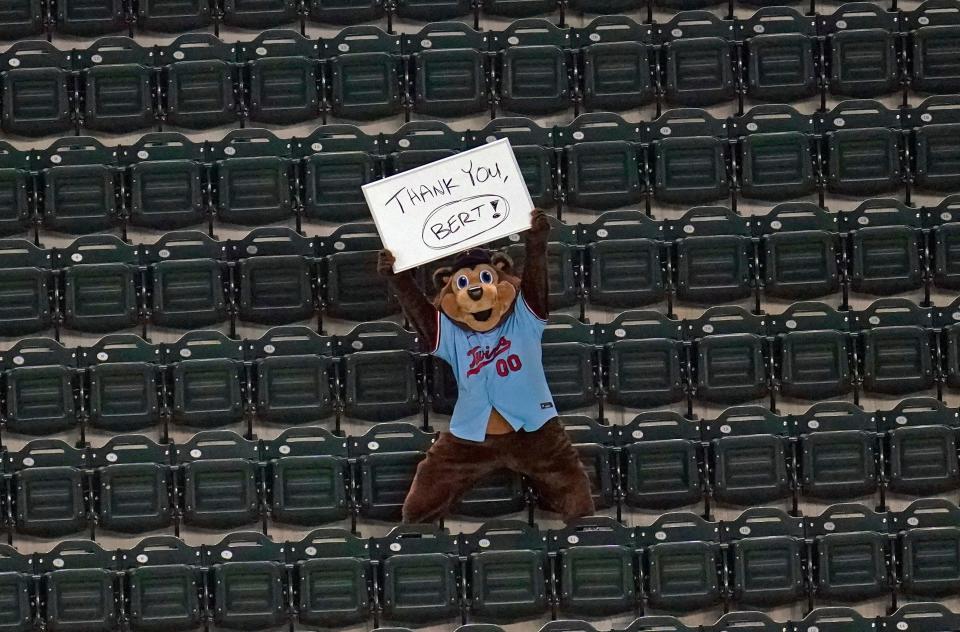 Minnesota Twins mascot TC Bear holds up a "Thank You Bert" sign to Twins' Hall of Famer Bert Blyleven on his last day in the broadest booth.