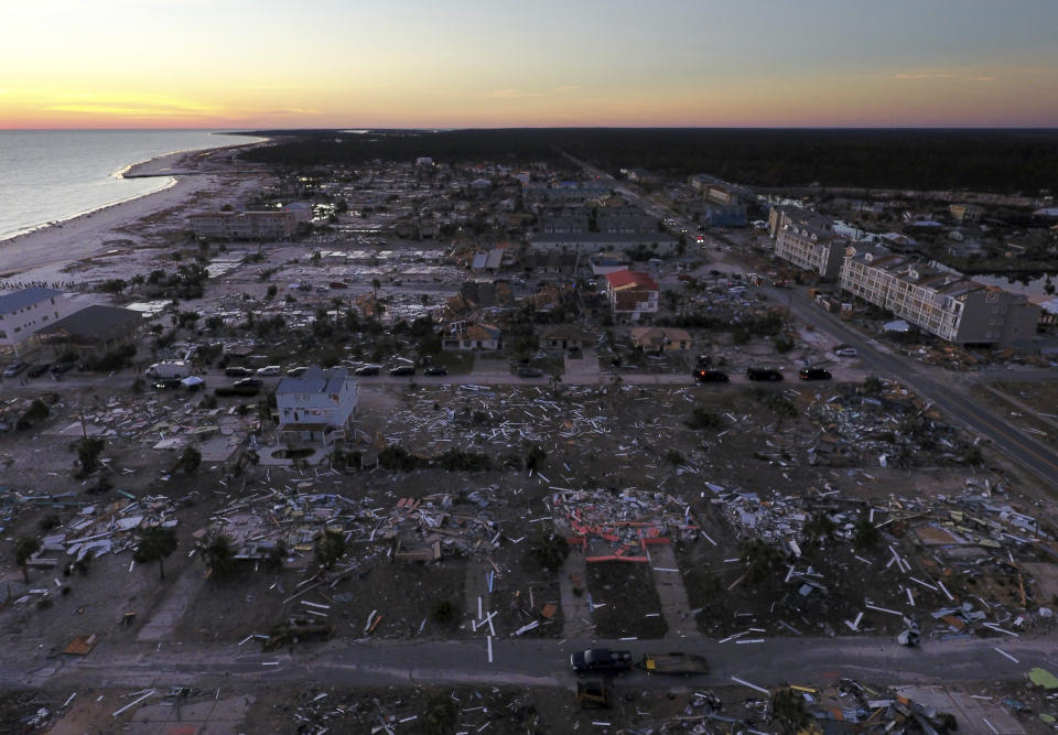 FILE - In this Oct. 12, 2018, file photo, damaged homes are seen along the water's edge in the aftermath of hurricane Michael in Mexico Beach, Fla. It was once argued that the trees would help save Florida’s Panhandle from the fury of a hurricane, as the acres of forests in the region would provide a natural barrier to savage winds that accompany the deadly storms. It’s part of the reason that tighter building codes, mandatory in places such as South Florida, were not put in place for most of this region until just 11 years ago. And it may be a painful lesson for area residents now that Hurricane Michael has ravaged the region (AP Photo/David Goldman, File)