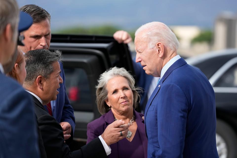 President Joe Biden greets Gov. Lujan Grisham, center, along with Sen. Ben Ray Lujan, D-N.M., and Sen. Martin Heinrich, D-N.M., back left, upon arrival at Kirtland Air Force Base, Tuesday, Aug. 8, 2023, in Albuquerque, N.M. (AP Photo/Alex Brandon)