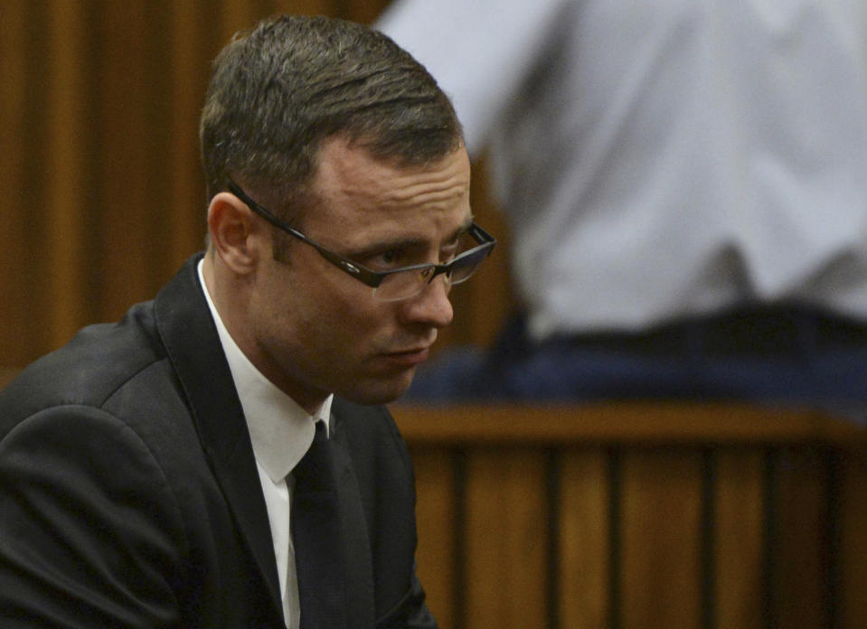 Oscar Pistorius sits in the dock during his murder trial at a court in Pretoria, South Africa, Friday, March 14, 2014. Pistorius is charged with the shooting death of his girlfriend Reeva Steenkamp, on Valentines Day in 2013. (AP Photo/Phill Magakoe, Pool)