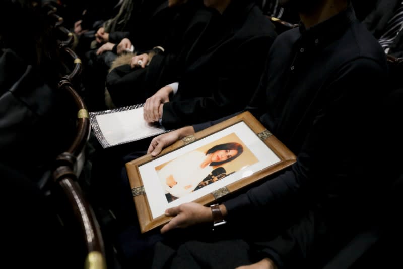 Mourners attend a memorial for the victims of a Ukrainian passenger plane which was shot down in Iran