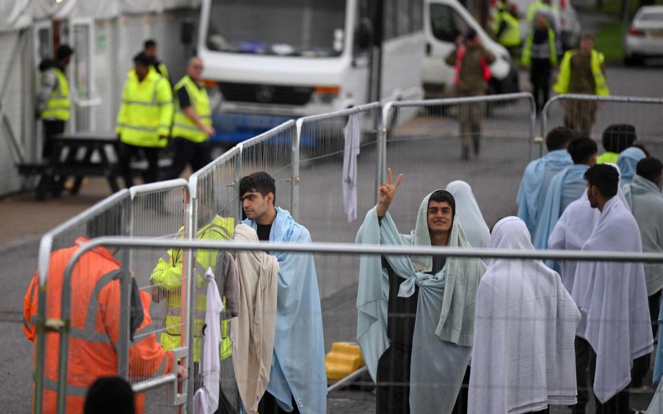 Detainees wrapped in blankets inside the Manston short-term holding centre for migrants, near Ramsgate - Daniel Leal/AFP via Getty Images