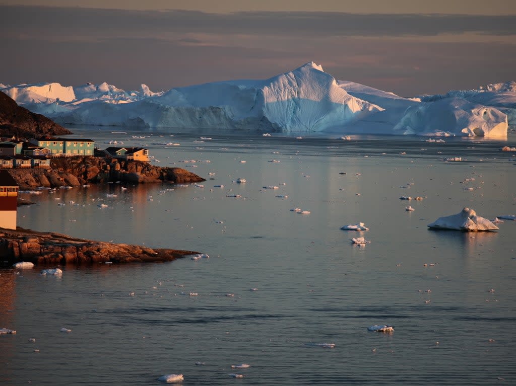 Greenland’s ice sheet is up to 9,800ft deep and would raise global sea levels by around 20ft if it melted entirely  (Getty)