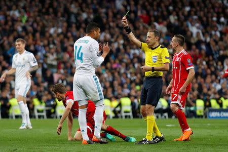 Soccer Football - Champions League Semi Final Second Leg - Real Madrid v Bayern Munich - Santiago Bernabeu, Madrid, Spain - May 1, 2018 Real Madrid's Casemiro is shown a yellow card by referee Cuneyt Cakir REUTERS/Paul Hanna