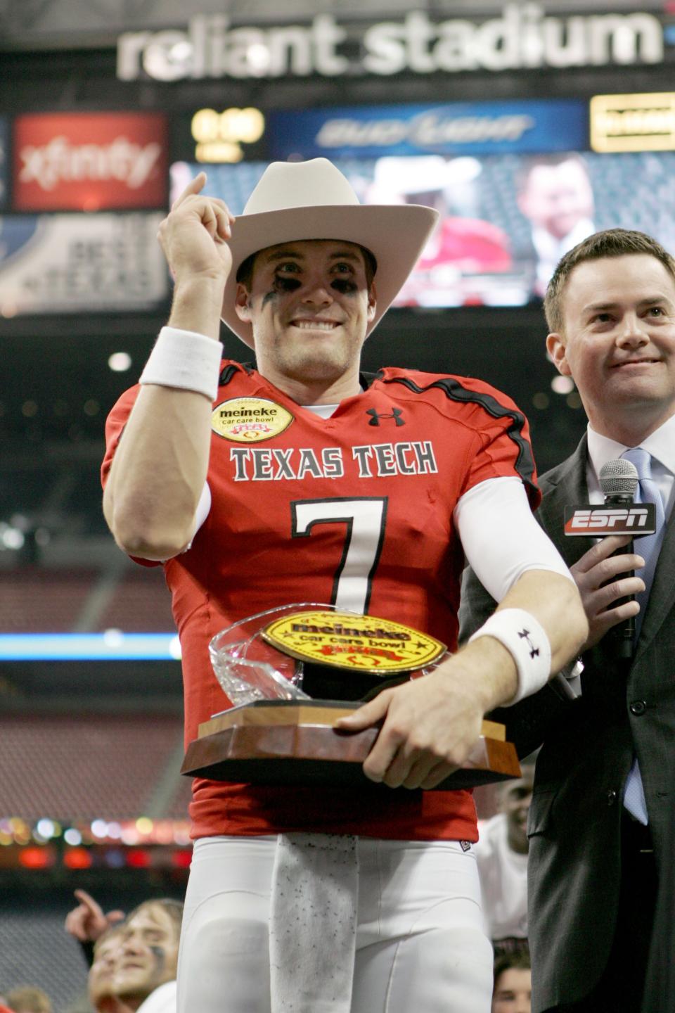 Dec 28, 2012; Houston, TX, USA; Texas Tech Red Raiders quarterback Seth Doege (7) accepts the most valuable player trophy after defeating the Minnesota Gophers in the Meineke Car Care Bowl at Reliant Stadium.  Mandatory Credit: Michael C. Johnson-USA TODAY Sports