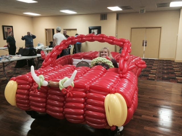 Dena Atchley sits in a life-size balloon car that she helped create in Heber Springs, Arkansas. Atchley has been a balloon artist for over 16 years, and she's known as The Balloon Lady in Springfield. Next month, Atchley is traveling to Kansas City to serve as a detail lead for the Big Balloon Build, an international balloon art festival.