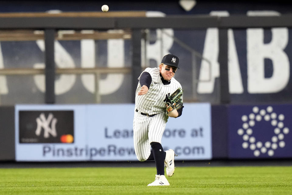 New York Yankees' Harrison Bader throws to first base after catching a fly out by Cleveland Guardians' Josh Naylor during the fifth inning of a baseball game Tuesday, May 2, 2023, in New York. (AP Photo/Frank Franklin II)