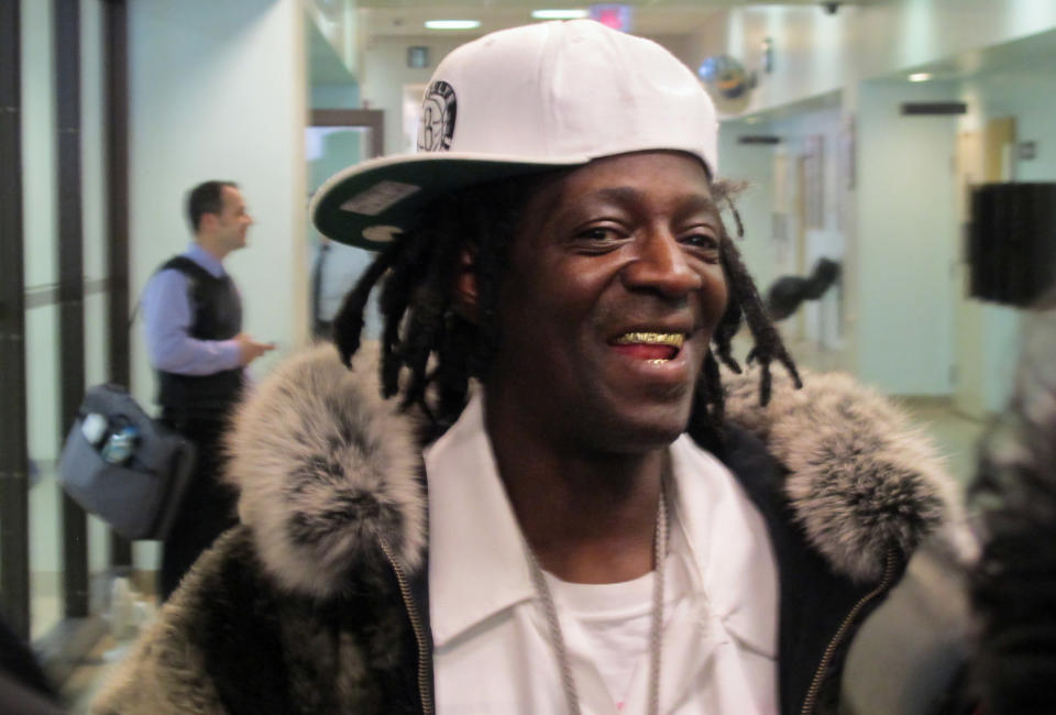 Flavor Flav speaks with reporters following an appearance in Nassau County District Court in Hempstead, N.Y., on Tuesday, Jan. 28, 2014. The rapper, whose real name is William Drayton, was in court on charges he was speeding and driving with a suspended license en route to his mother's funeral in Long Island on Jan. 9. Drayton pleaded not guilty Tuesday and was released without bail. (AP Photo/Frank Eltman)