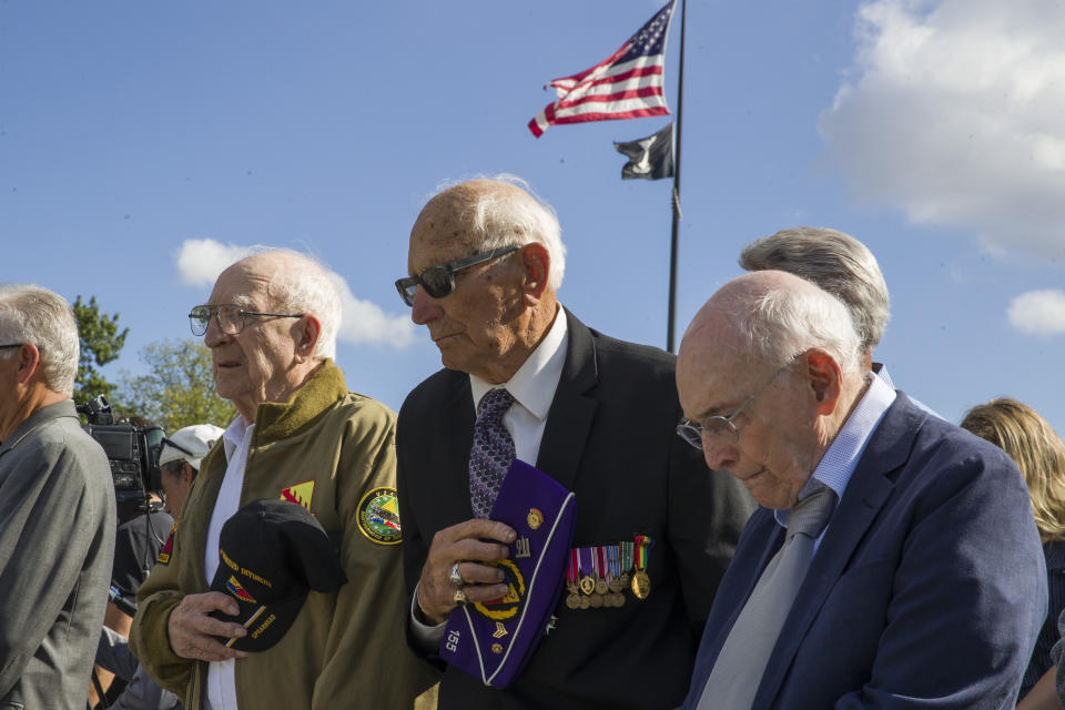World War II veterans Clarence Smoyer, 96, left, Joseph Caserta and Buck Marsh bow their heads during a ceremony to present the Bronze Star to Smoyer at the World War II Memorial, Wednesday, Sept. 18, 2019, in Washington. Smoyer fought with the U.S. Army's 3rd Armored Division, nicknamed the Spearhead Division. In 1945, he defeated a German Panther tank near the cathedral in Cologne, Germany — a dramatic duel filmed by an Army cameraman that was seen all over the world. (AP Photo/Alex Brandon)