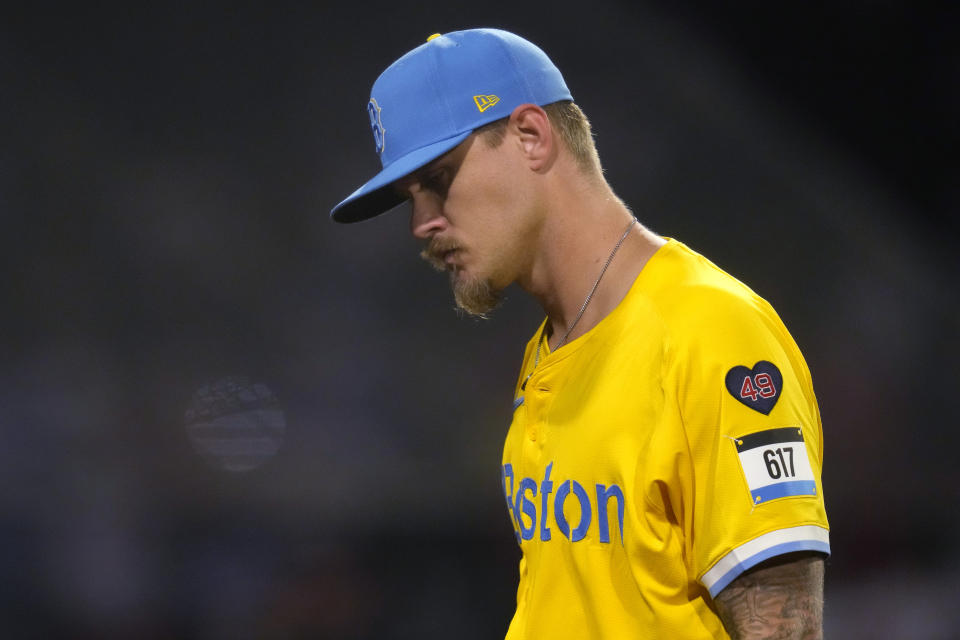 Boston Red Sox pitcher Tanner Houck heads to the dugout after being pulled during the sixth inning of the team's baseball game against the Los Angeles Angels, Friday, April 12, 2024, in Boston. (AP Photo/Charles Krupa)