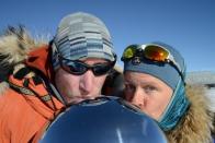 Keith and Dr. Ross kiss the South Pole marker.