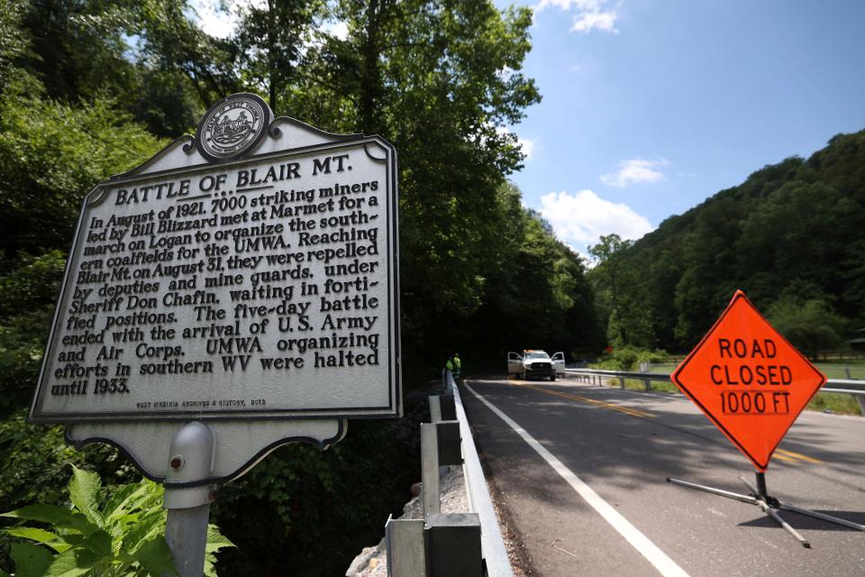 The road is closed after a helicopter crash  in Blair, W.Va., on Thursday, June, 23, 2022. A Vietnam-era helicopter was used for tourism flights and crashed along Route 17 in Logan County about 5 p.m. Wednesday. County emergency ambulance service executive Ray Bryant says all six on board were killed. (AP Photo/Chris Jackson)