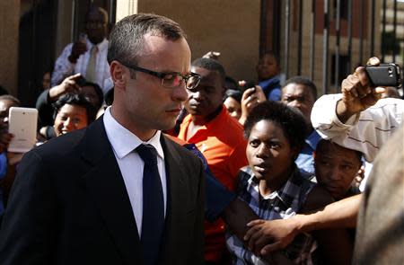 Olympic and Paralympic track star Oscar Pistorius (L) leaves after his trial for the murder of his girlfriend Reeva Steenkamp, at the North Gauteng High Court in Pretoria, March 24, 2014. REUTERS/Siphiwe Sibeko