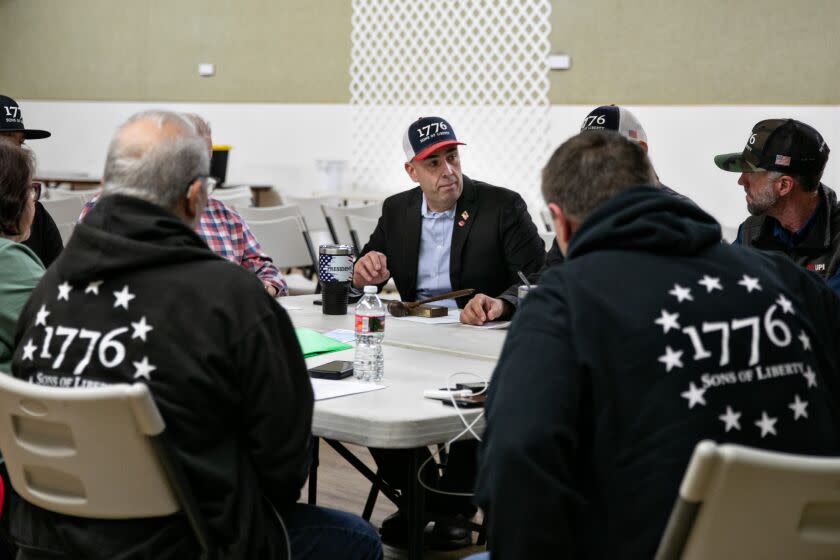 HANFORD, CA - JANUARY 09: (center) Larry Faria, president of 1776 Sons of Liberty meets with board members of the 1776 Sons of Liberty on Monday, Jan. 9, 2023 in Hanford, CA. (Jason Armond / Los Angeles Times)
