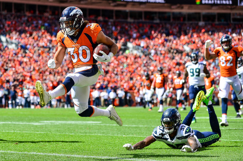 <p>Running back Phillip Lindsay #30 of the Denver Broncos scores a first quarter touchdown on a reception as cornerback Tre Flowers #37 of the Seattle Seahawks falls to the ground during a game at Broncos Stadium at Mile High on September 9, 2018 in Denver, Colorado. (Photo by Dustin Bradford/Getty Images) </p>