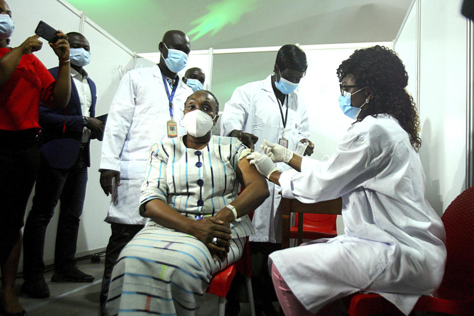 Raimonde Goudou Coffie , culture minister, receives a shot of the AstraZeneca vaccine in Abidjan, Ivory Coast, Monday March 1, 2021. Ivory Coast is the second country in the world after Ghana to receive vaccines acquired through the United Nations-backed COVAX initiative with a delivery of 504,000 doses of the AstraZeneca vaccine made by the Serum Institute of India. (AP Photo/ Diomande Ble Blonde)