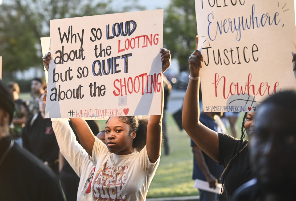 Jamiya Billings holds a sign during a protest in downtown Decatur, Ala., Friday, Oct. 6, 2023, against the killing of Steve Perkins by police a week earlier. (Jeronimo Nisa/The Decatur Daily via AP)