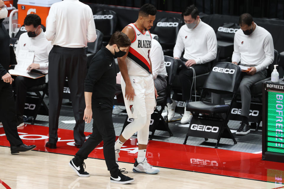 PORTLAND, OREGON - JANUARY 16: CJ McCollum #3 of the Portland Trail Blazers has a conversation with a team attendant in the second quarter against the Atlanta Hawks at Moda Center on January 16, 2021 in Portland, Oregon. NOTE TO USER: User expressly acknowledges and agrees that, by downloading and or using this photograph, User is consenting to the terms and conditions of the Getty Images License Agreement. (Photo by Abbie Parr/Getty Images)