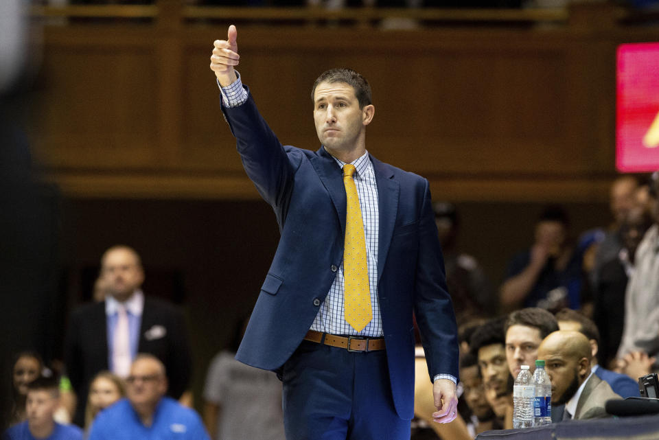 Brown head coach Mike Martin directs his team during the first half of an NCAA college basketball game against Duke in Durham, N.C., Saturday, Dec. 28, 2019. (AP Photo/Ben McKeown)